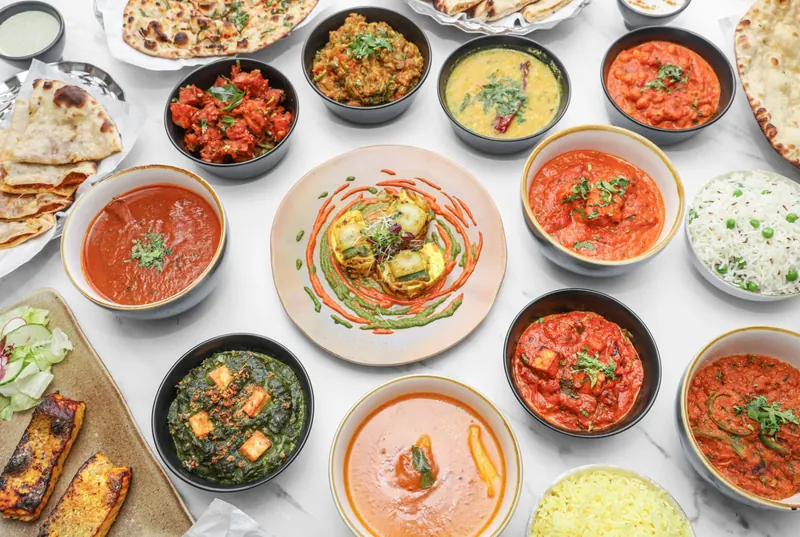A spread of Indian curries, breads and rice for private dining and catering